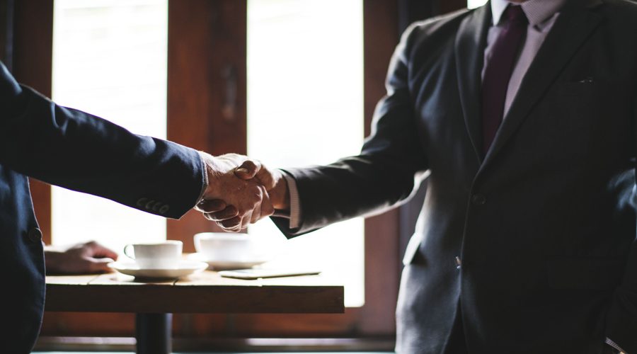 Handshake between two successful business people in the office